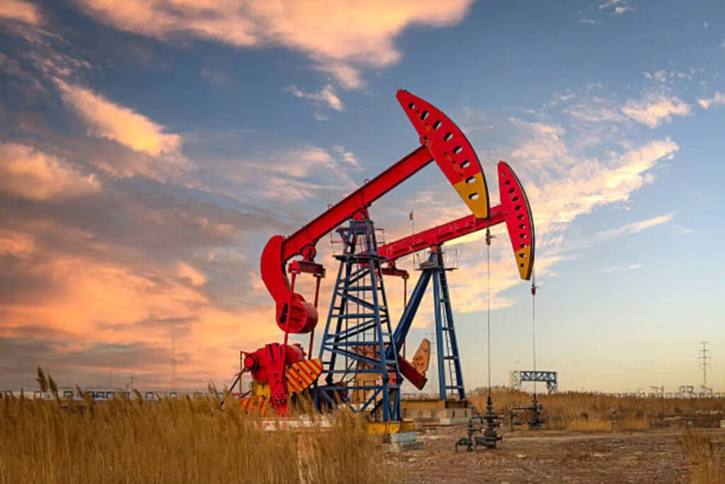The pumping unit under the sunset in the oil field