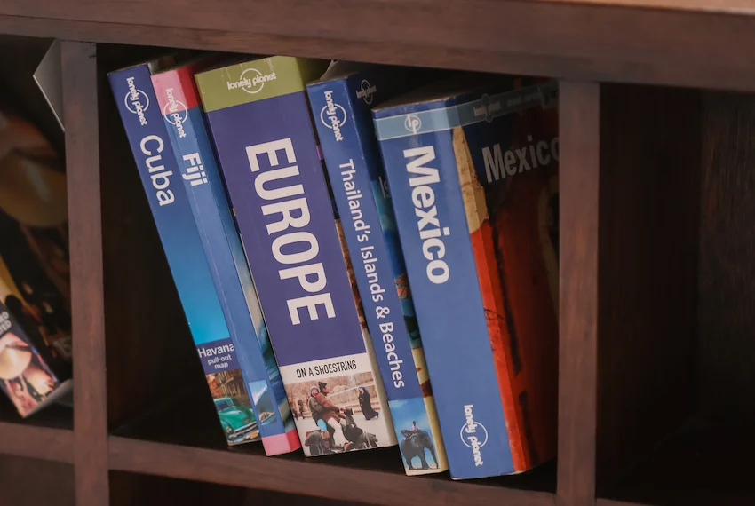 Am I being disrespectful? A reflection on living in San Miguel as an American intern collection of overseas travel books lined up on bookshelf