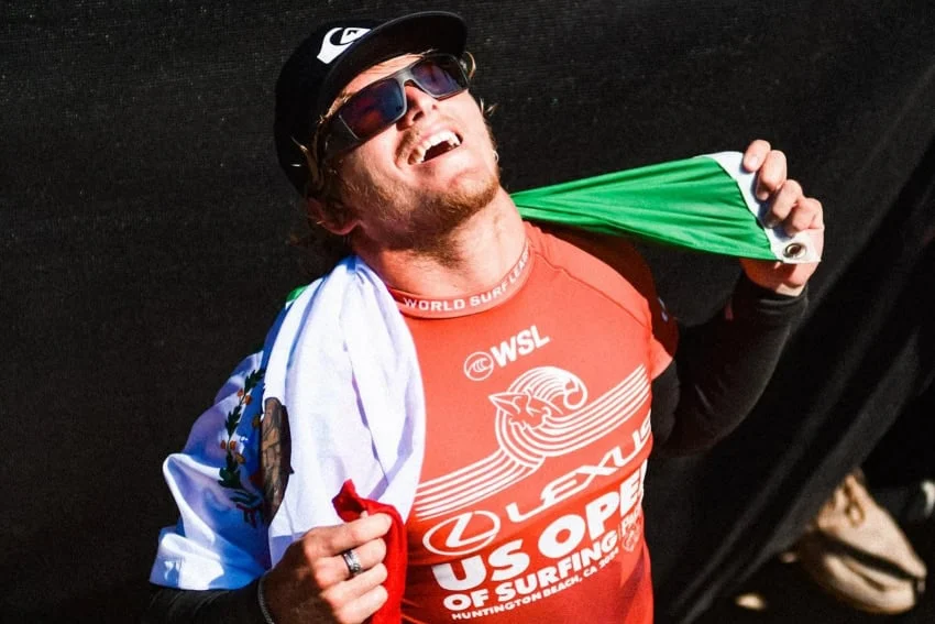 Celebrities Who You Might Not Realize Are Mexican Alan Cleland, proudly displaying the Mexican flag after a surfing victory.