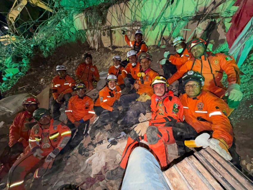 Topo Azteca rescue brigade aids Venezuela after earthquakes A group of Topo Azteca rescue brigade members on a pile of rubble from a collapsed building