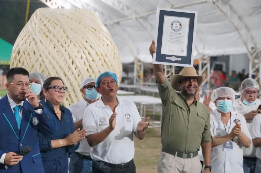 Chiapas town reclaims record for world’s biggest cheese ball A man holds up a Guiness World Record plaque in front of a giant ball of quesillo string cheese