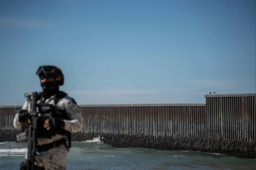 Mexican Army arrests drone operator in Tijuana on US intel National Guard troops patrol the beach along the U.S. border wall in Tijuana in February.