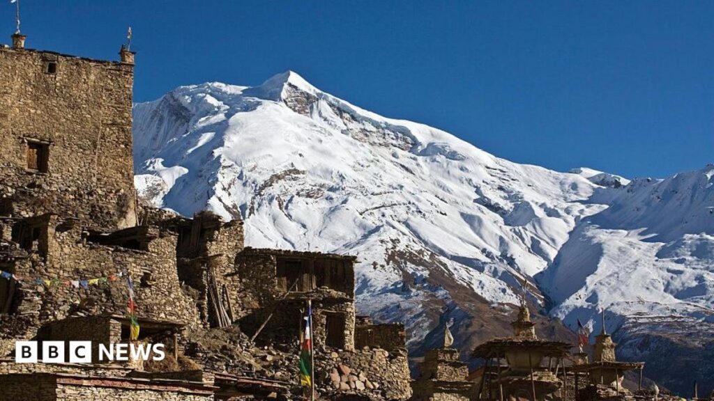 The peaks of Himlung Himal rising over a Neapli village