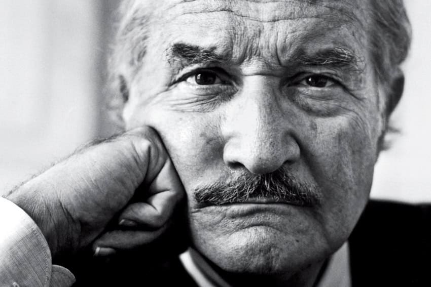 Made in Mexico: Carlos Fuentes and the stories that define a nation Carlos Fuentes (an old man) staring into the camera lens with his fist on his cheek.