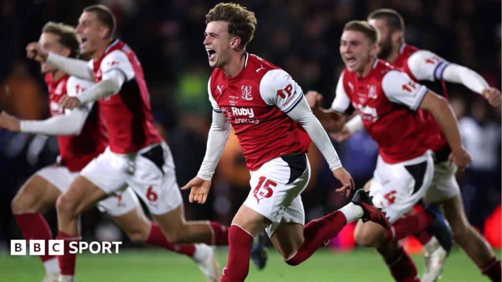 Fleetwood's players celebrate after beating Premier League champions Arsenal in the League Cup fourth round